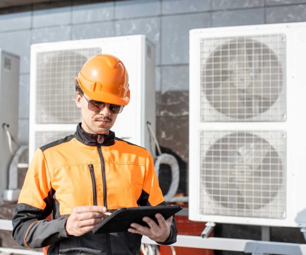 workman-servicing-air-conditioning-or-heat-pump-wi-2021-09-02-01-01-30-utc